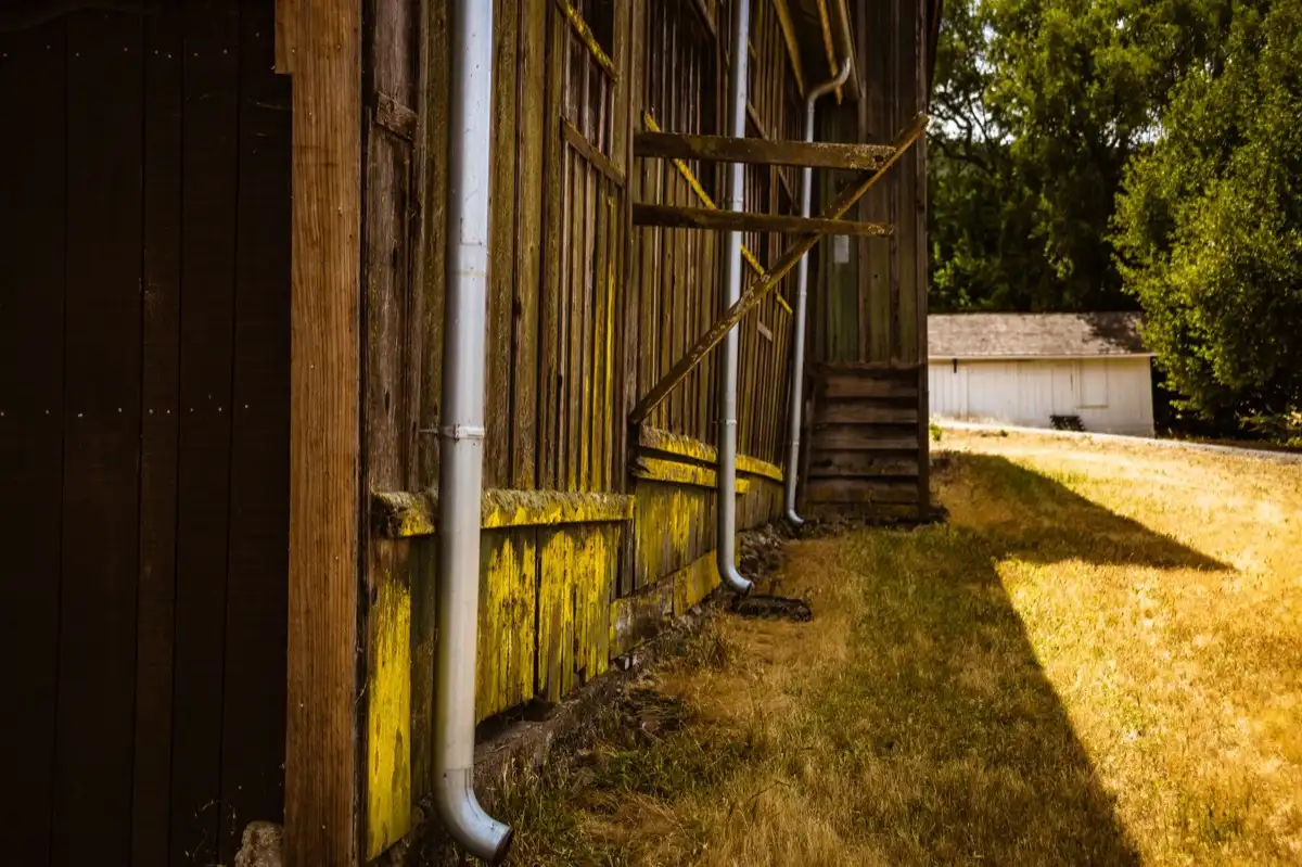 Downspout discharging beside a foundation wall on a house in San Mateo, CA