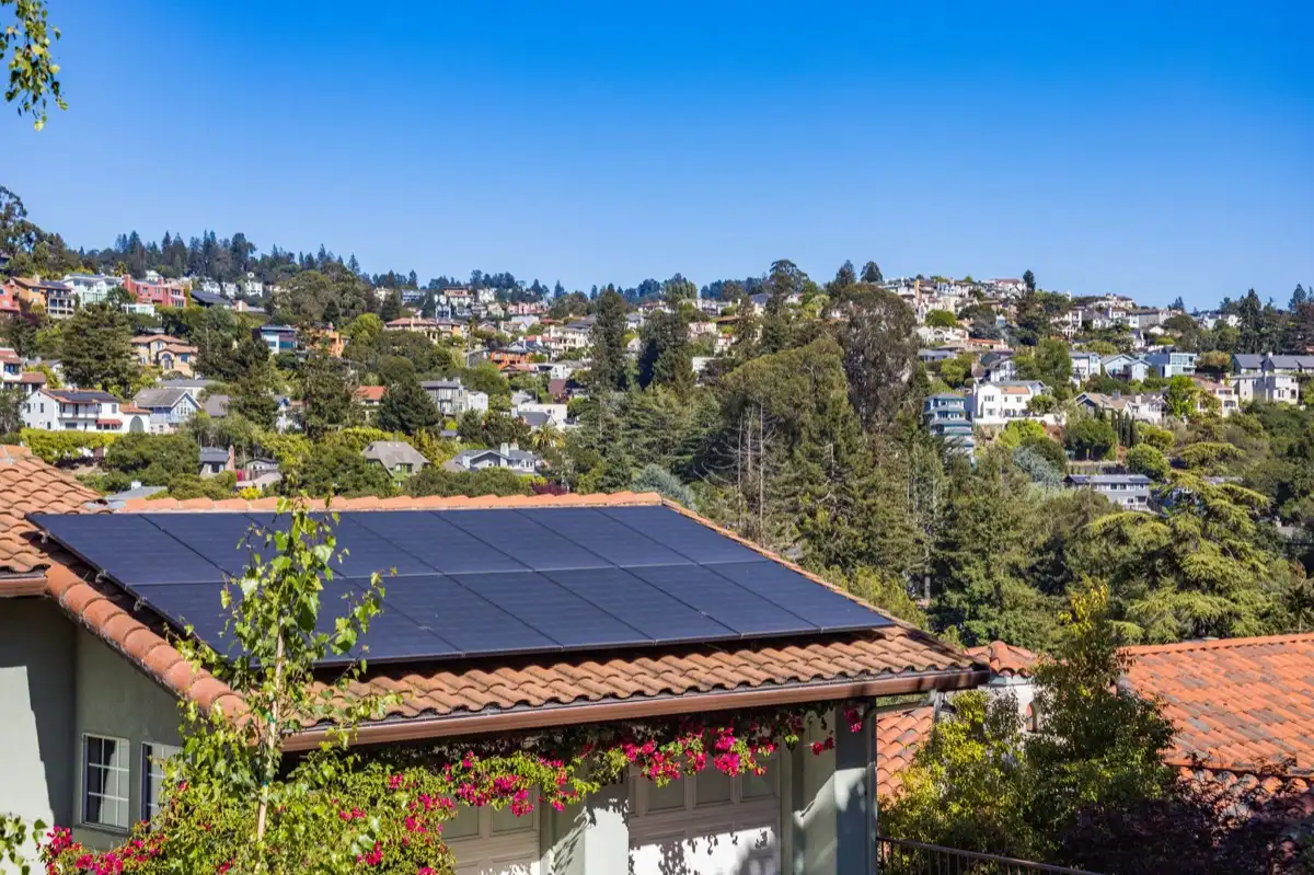 Neighborhood of roofs in San Mateo, CA after a storm, where every household is running the same claim process